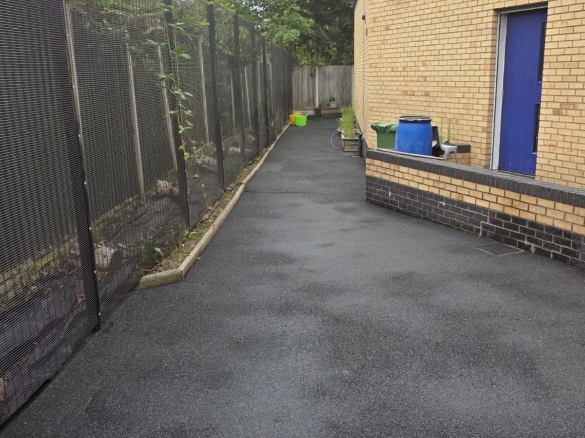 Weed grown tarmac path beside a commercial building, and the same path cleaned