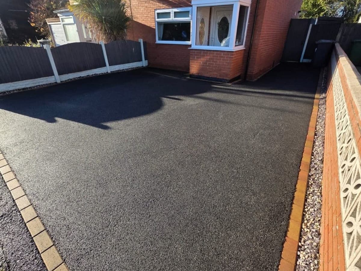 Faded patchy tarmac driveway, and the same driveway restored to a deep black finish