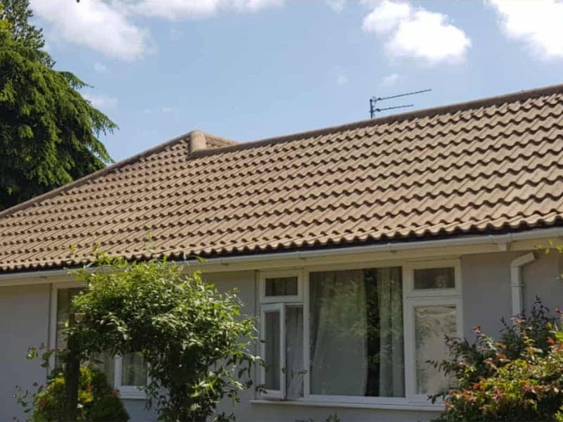 Pitched tiled roof being soft washed